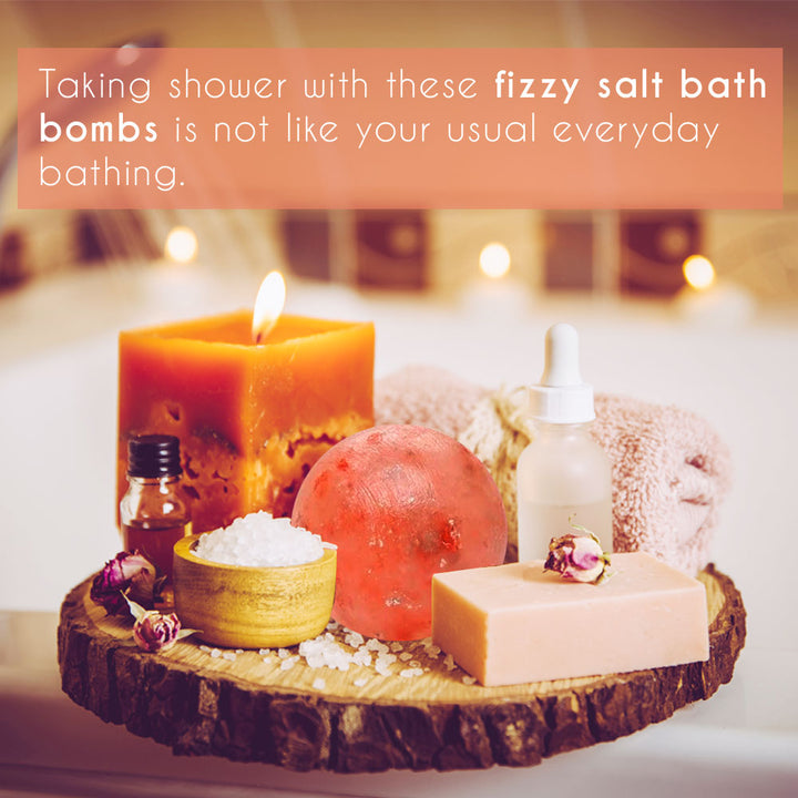 Himalayan Pink Salt Bath Ball with natural oils, candle, and soap on wooden tray, offering a calming bath experience.