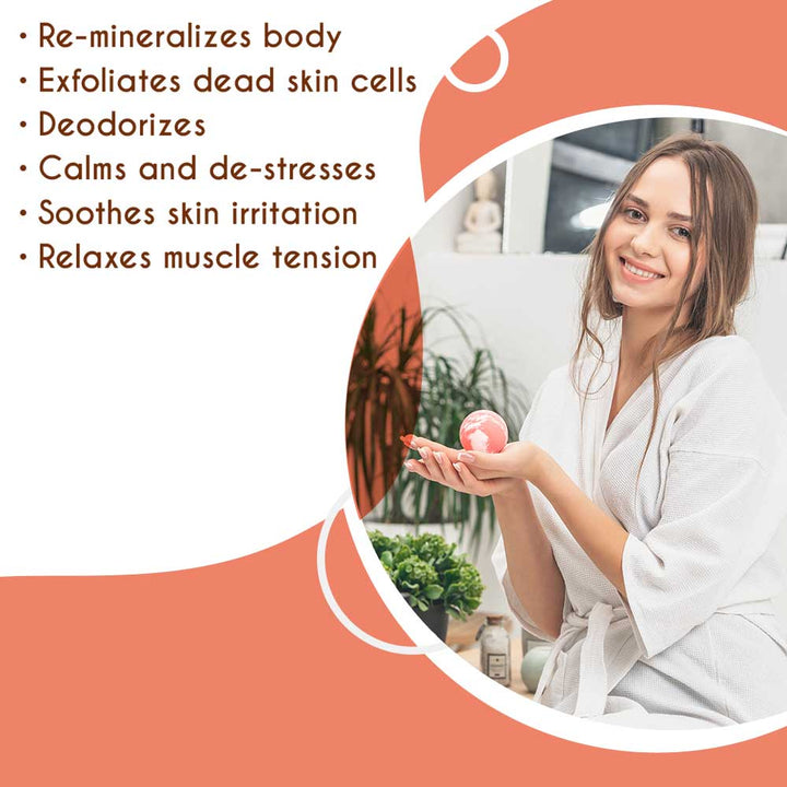 Woman holding Himalayan pink salt bath ball, benefits include calming, deodorizing, exfoliating, soothing skin, and relaxing muscles.