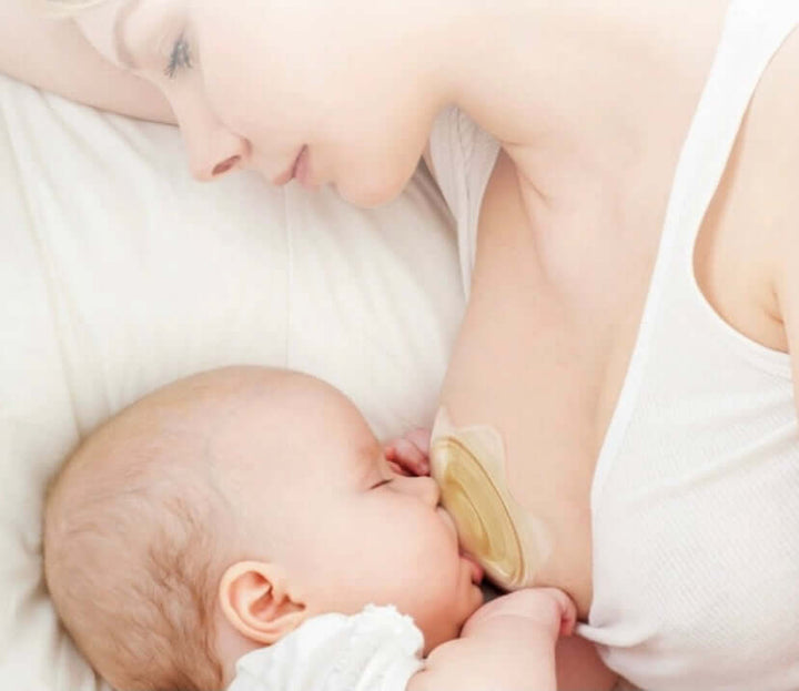 A mother breastfeeding her baby using a BPA/BPS-free silicone nipple shield for gentle nursing support.