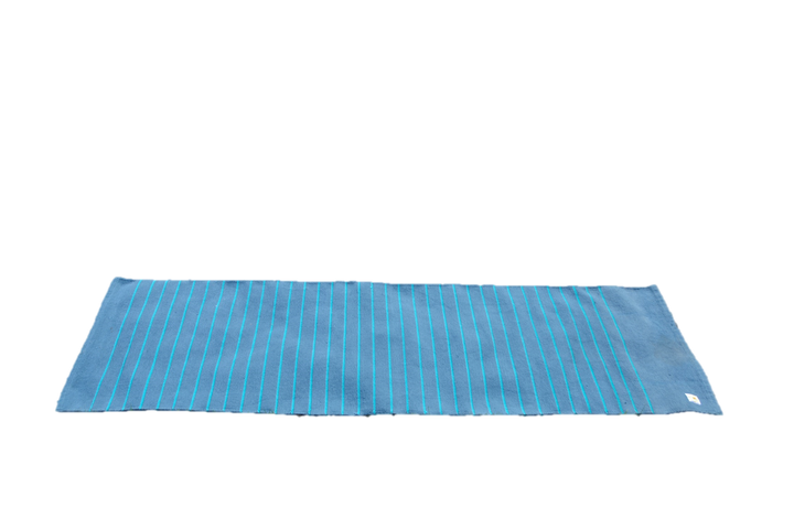 Handwoven cotton yoga rug with blue stripes for meditation and ashtanga yoga, featuring an OM design, fringes, and eco-friendly material.
