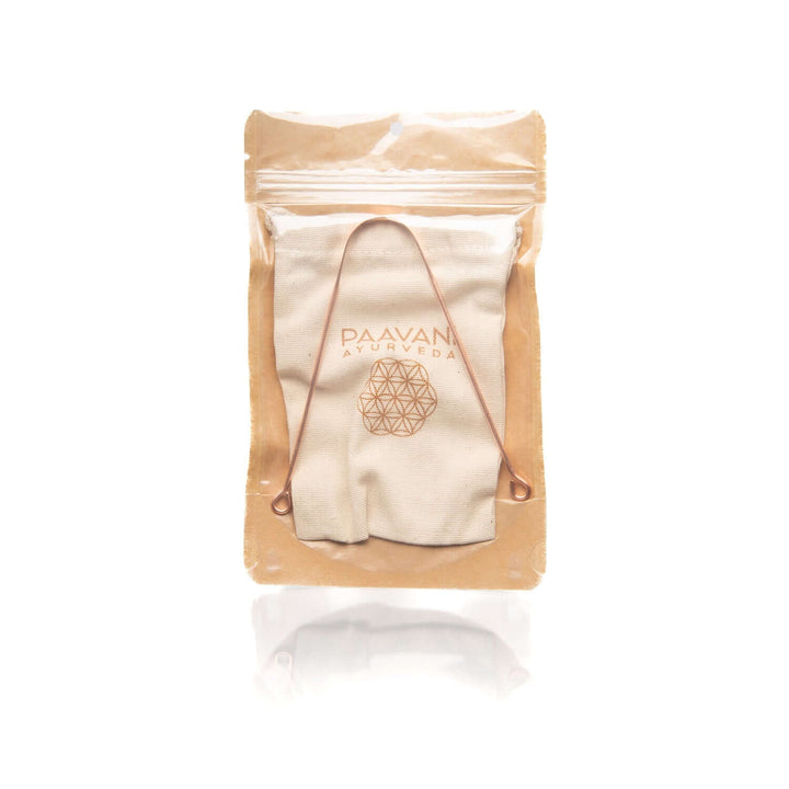 Copper tongue cleaner in packaging, Ayurvedic tool for daily oral hygiene, removes toxins and bacteria for fresh breath.