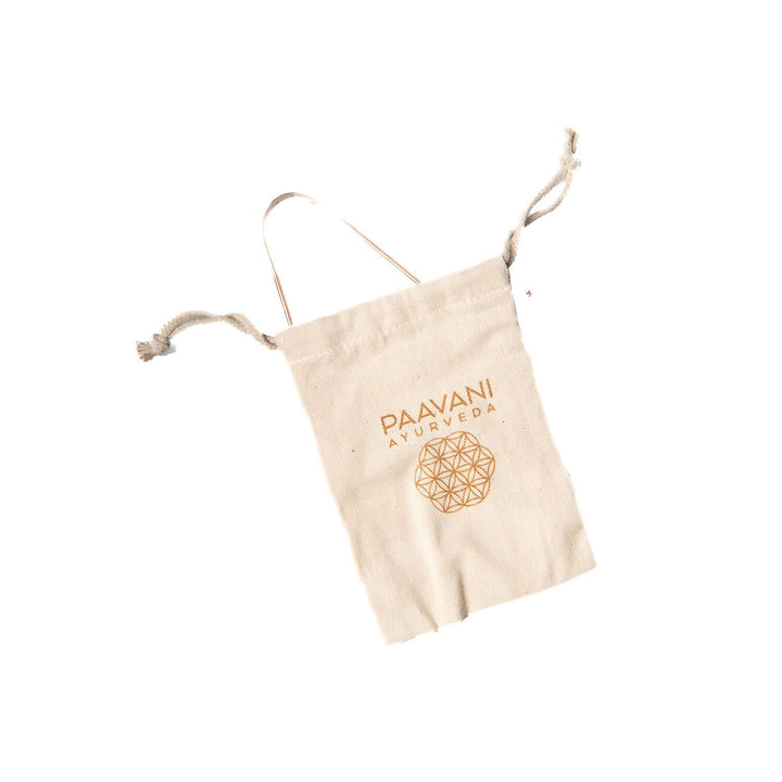 Cotton pouch with 'Paavani Ayurveda' logo for copper tongue cleaner storage.