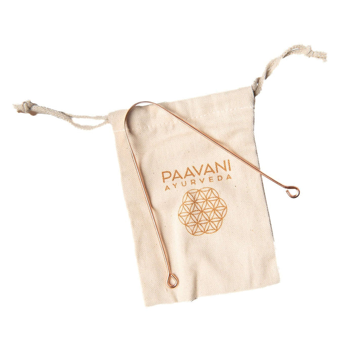 Copper tongue cleaner on cloth bag with logo; Ayurvedic tool for oral hygiene and toxin removal.