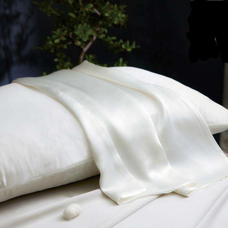 King size light ivory silk pillowcase with envelope closure draped elegantly, made from premium 22 momme mulberry silk.