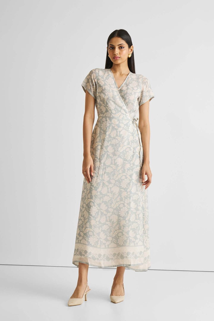 Woman wearing a blue floral maxi wrap dress made from sustainable Bemberg™ crepe, perfect for casual and evening occasions.
