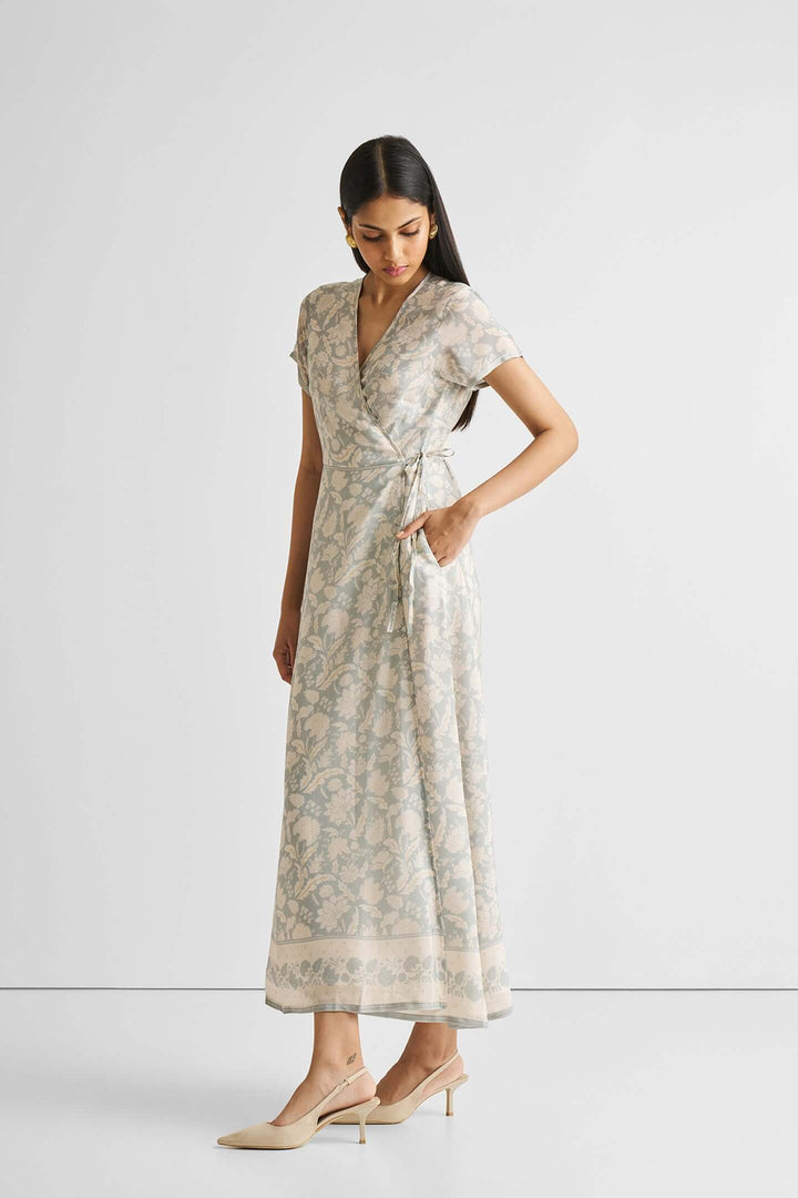 Maxi wrap dress with blue floral pattern, sustainable Bemberg™ crepe, modeled gracefully in a light setting.