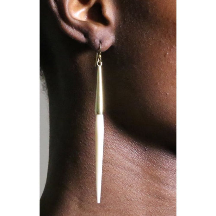 Capped Quill Minimalist Dangle Earring in bright white displayed on ear, showcasing its lightweight, elegant design, perfect for everyday wear.