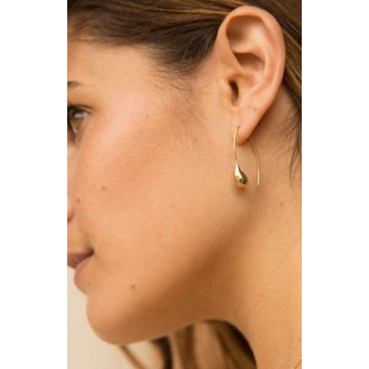 Woman wearing elegant Dash Threader Drop Earrings made from recycled brass, showcasing ethical jewelry design with smooth fit.