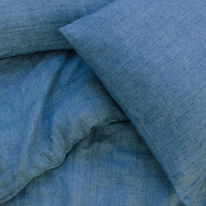Denim blue linen duvet cover set, made from Belgian flax, featuring temperature-regulating and moisture-wicking benefits.