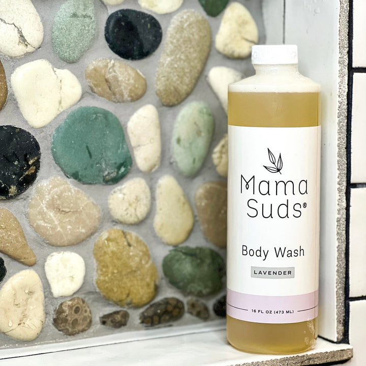 Mama Suds Plant Based Body Wash with Lavender, 16 oz bottle, on stone surface in bathroom setting