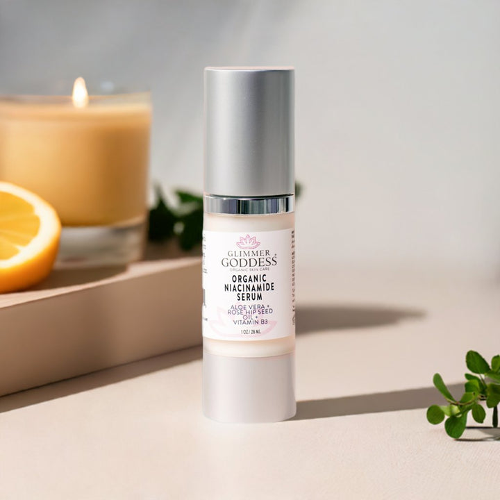 Organic Niacinamide Serum with candle and lemon in background for glowing skin. Contains 5% Niacinamide, Rosehip Seed Oil, Shea Butter.