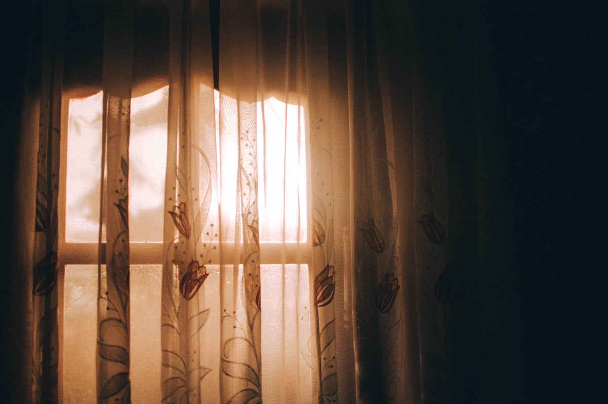 Warm morning light through curtains