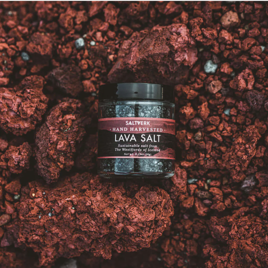 Jar of hand harvested lava salt placed on vibrant red lava rocks, symbolizing Non Toxic Home Supplies for a natural pantry.