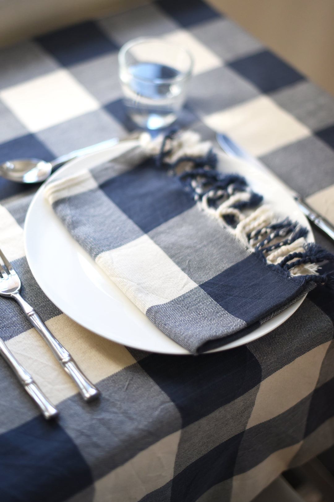 Handwoven ivory navy gingham Turkish cotton hand towel with classic checkered pattern on white background