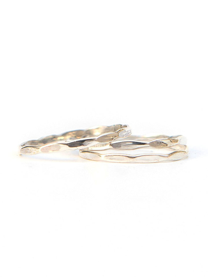 Delicate sterling silver wave stacking rings with textured ocean-inspired pattern, handcrafted by women artisans