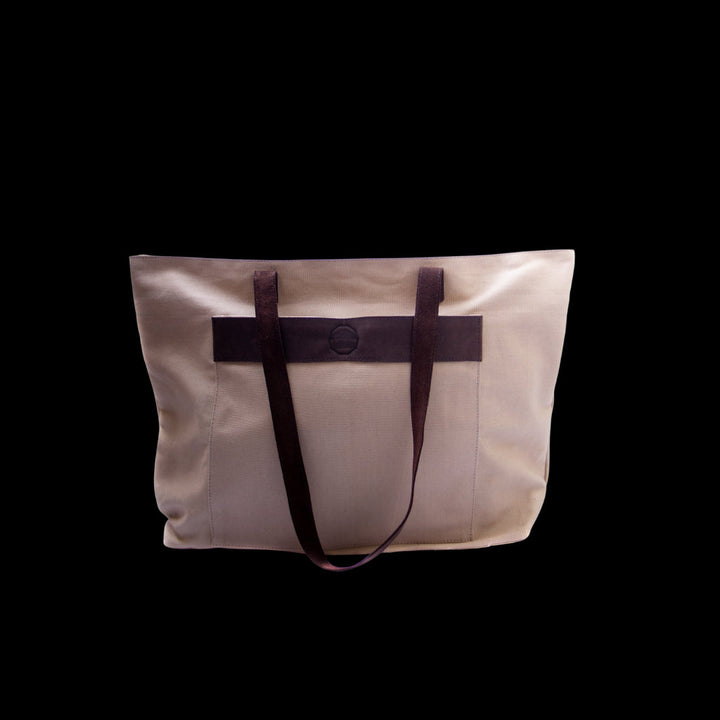 Canvas weekender bag in neutral tone with clean lines and sturdy handles for travel