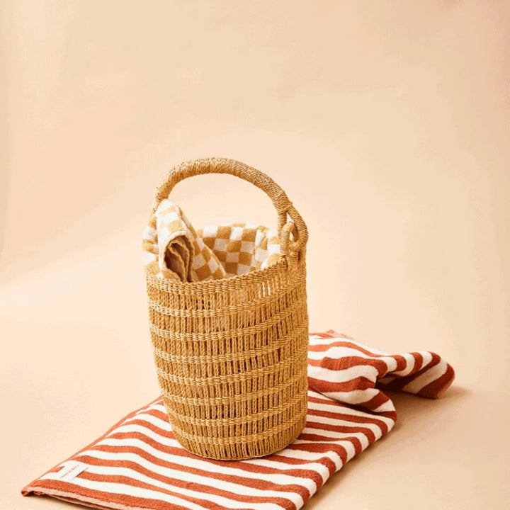 Handwoven bucket bag with open weave design made from natural elephant grass by Ghanaian artisans