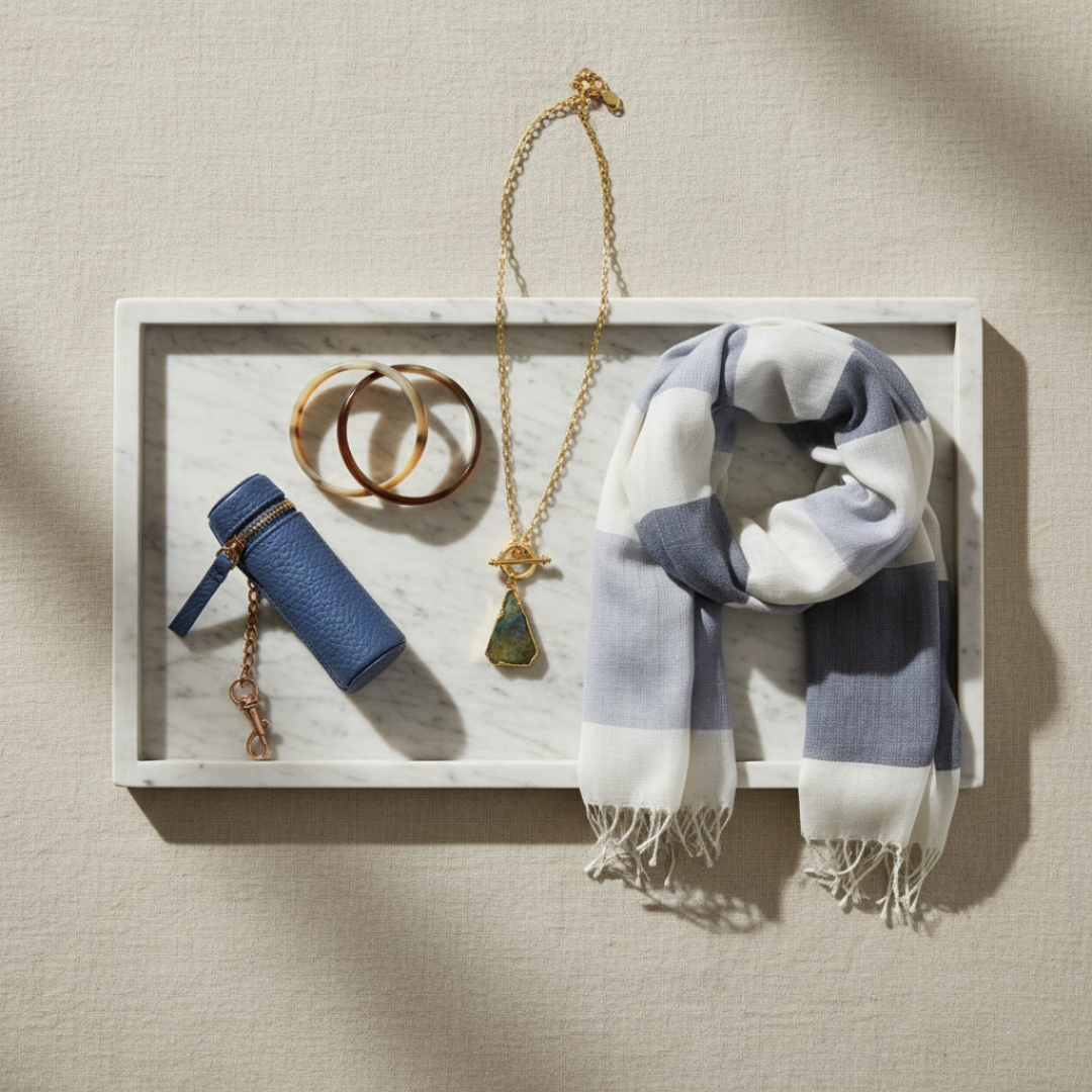 Style kit accessories including scarf, jewelry, and lipstick case on a marble tray, part of the Natural Style Curated Discovery Bundle.