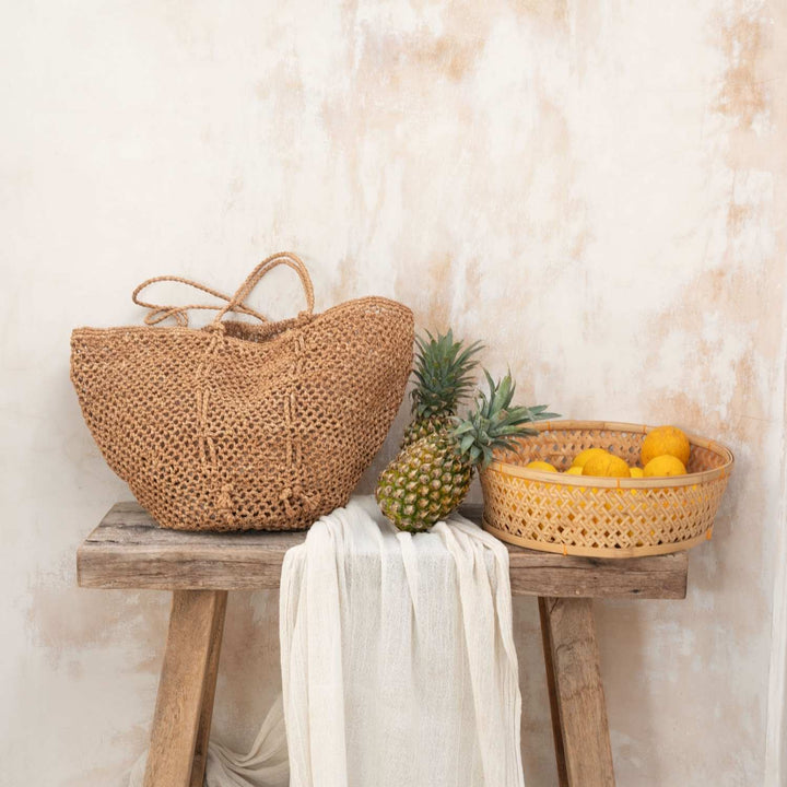 Handwoven raffia tote bag with natural palm fiber texture and traditional Madagascar weaving patterns