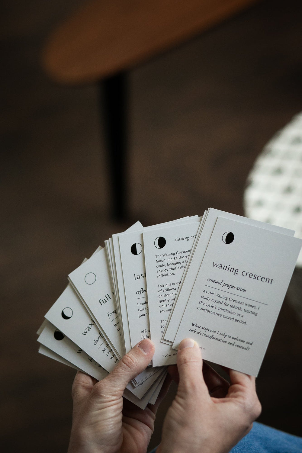 Person holding Lunar Reflections Mindfulness Cards showcasing moon phase information for enhancing mindfulness.