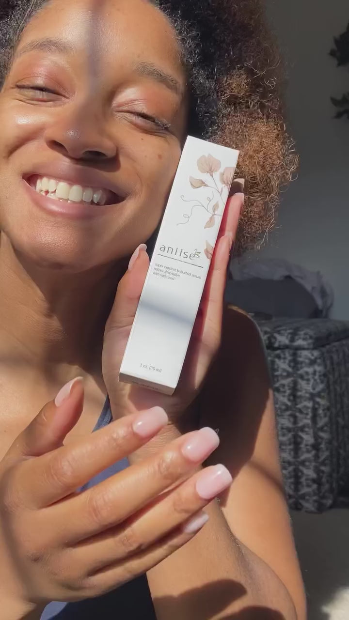 Person holding Bakuchiol Serum box, smiling in natural light