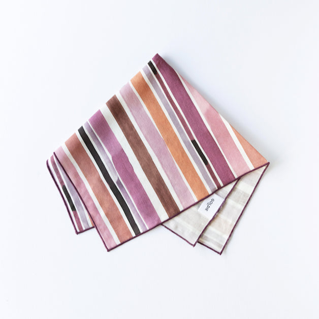 Hand painted linen napkin with pink plum rust stripe pattern on natural linen background
