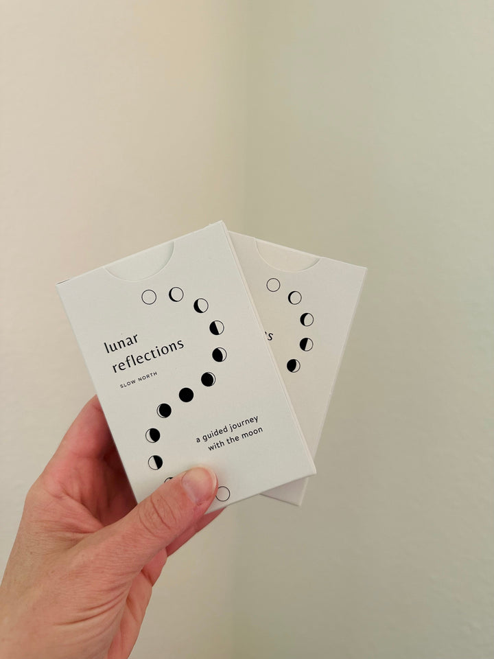 Hand holding Lunar Reflections Mindfulness Cards, Moon Phase Deck for aligning with lunar cycles.