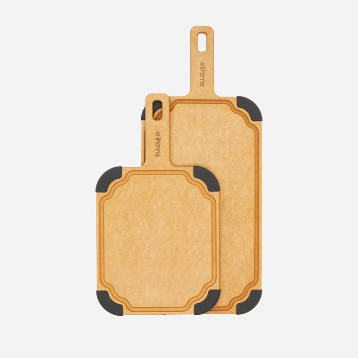 Natural paddle cutting board with juice groove and non-slip feet on kitchen counter