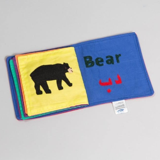Handmade Arabic English bilingual animal learning book with soft textured pages showing animal illustrations