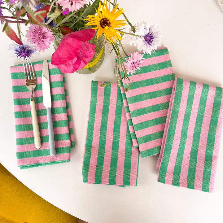 Handwoven striped cloth napkins in light pink and kelly green stripes made by Guatemalan artisans