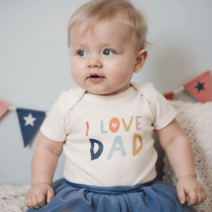 Organic cotton toddler t-shirt with Love Dad text in simple black lettering on natural cotton fabric
