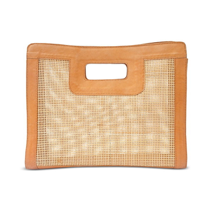 Handwoven honey brown rattan top handle bag with leather accents on neutral background
