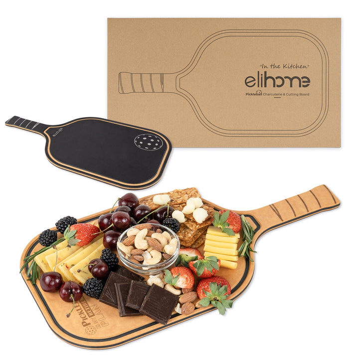 Paddle shaped cutting board with pickleball retirement plan engraving and charcuterie spread