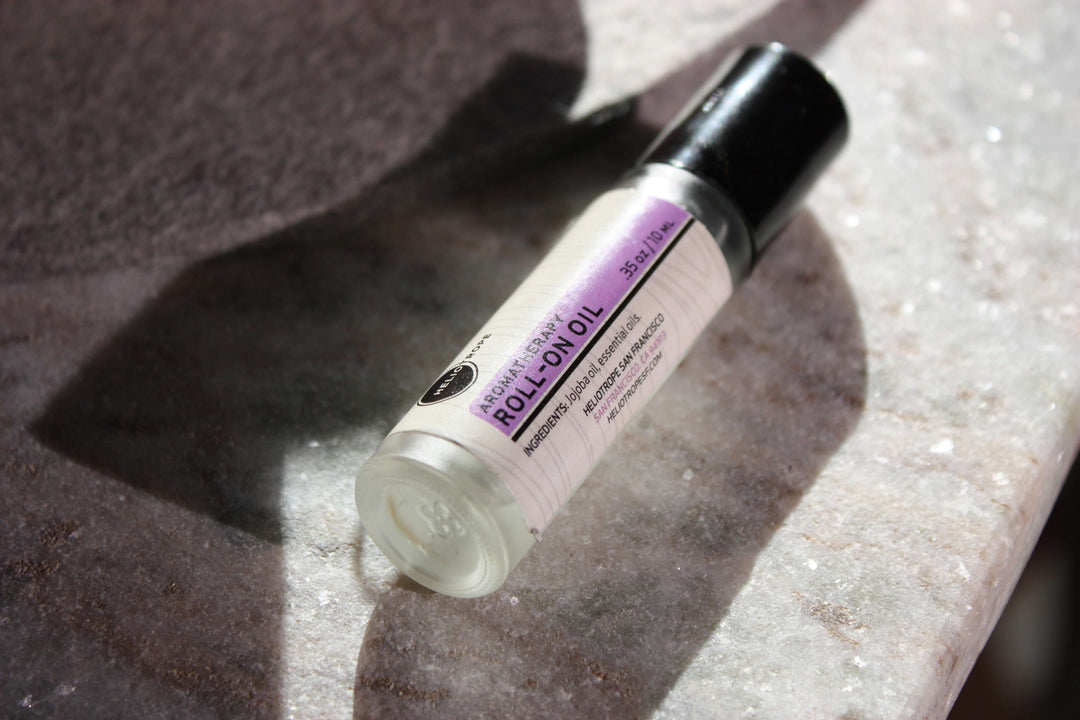 Aromatherapy Roll-On Oil on marble surface, made with pure essential oils and jojoba base, offering natural scent for grounding and relaxation.