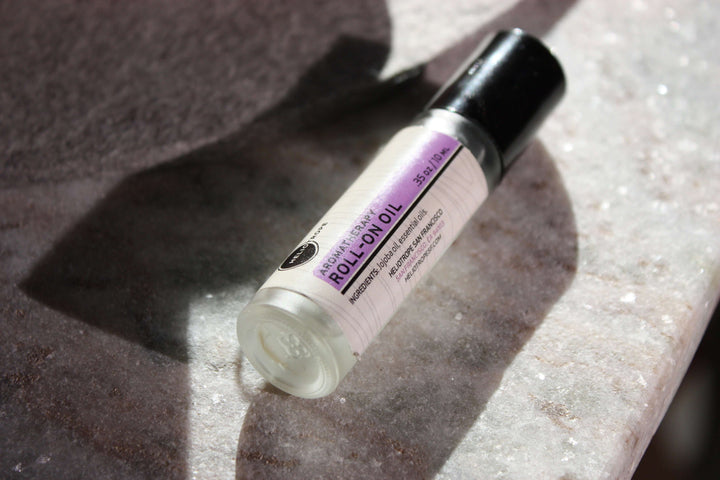 Aromatherapy Roll-On Oil on marble surface, made with pure essential oils and jojoba base, offering natural scent for grounding and relaxation.