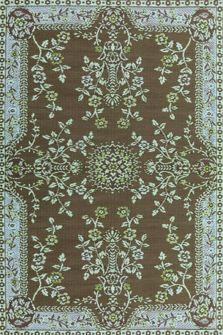 Teal and brown oriental pattern outdoor mat made from recycled materials on deck
