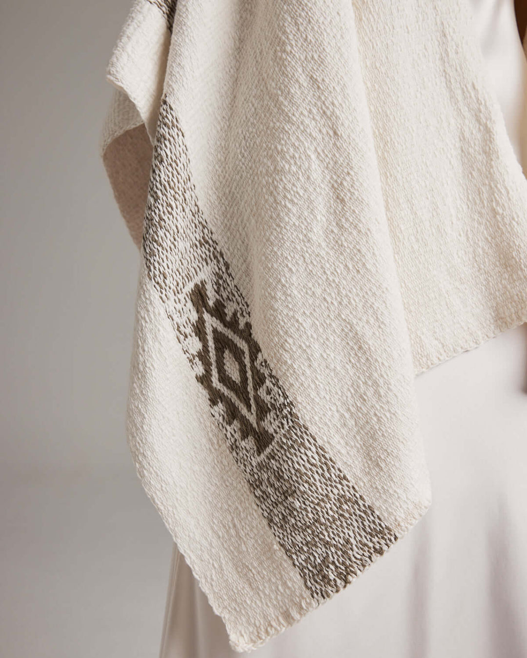 Detail of Long Estrella Textured Cotton Duster with Estrella symbol, handmade from organic cotton by Mapuche artisans in Chile.