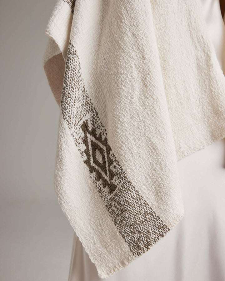 Detail of Long Estrella Textured Cotton Duster with Estrella symbol, handmade from organic cotton by Mapuche artisans in Chile.