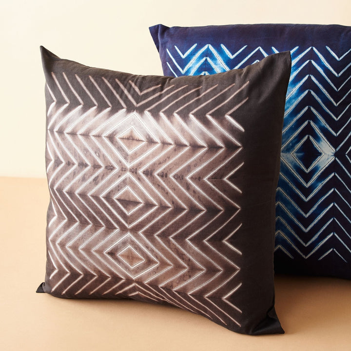 Black and white shibori wave pattern on handcrafted mulberry silk pillow with geometric design
