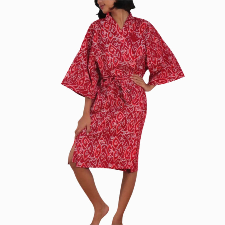 Hand dyed burgundy red batik cotton kimono robe with Storm pattern hanging against white background