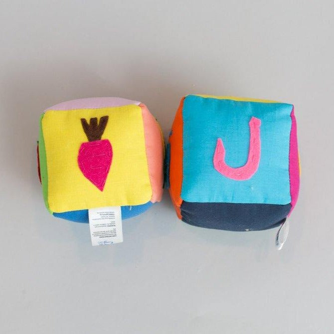 Handmade Arabic vegetable learning blocks with colorful fabric showing vegetables and Arabic letters for children
