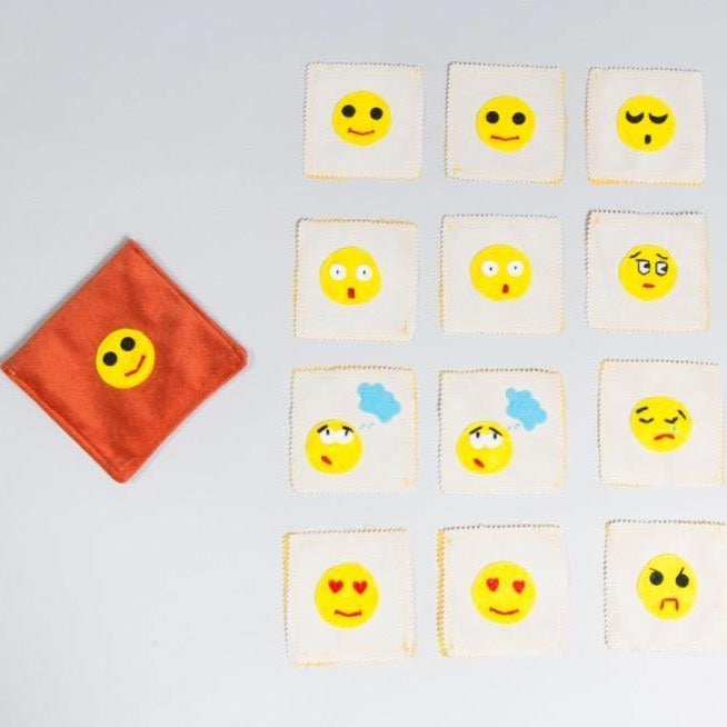 Handmade felt emotions memory game with colorful emotion pairs in portable carrying case