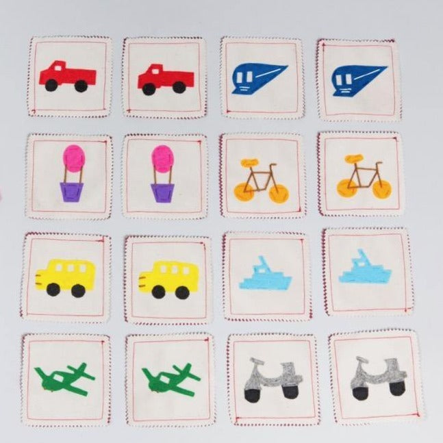 Handmade transportation memory game with felt pieces showing cars, trains, boats in carrying case