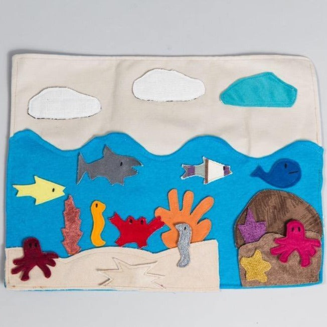 Educational sea habitat storyboard with felt ocean animals and marine creatures on portable fabric mat for children