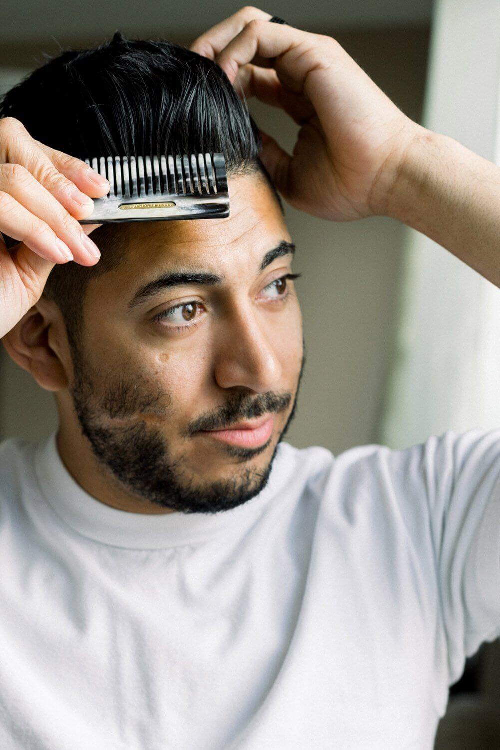 Man using Chai Buffalo Horn Pocket Comb on hair