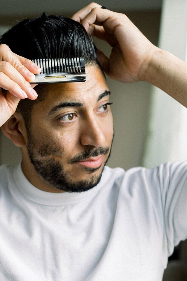 Man using Chai Buffalo Horn Pocket Comb on hair
