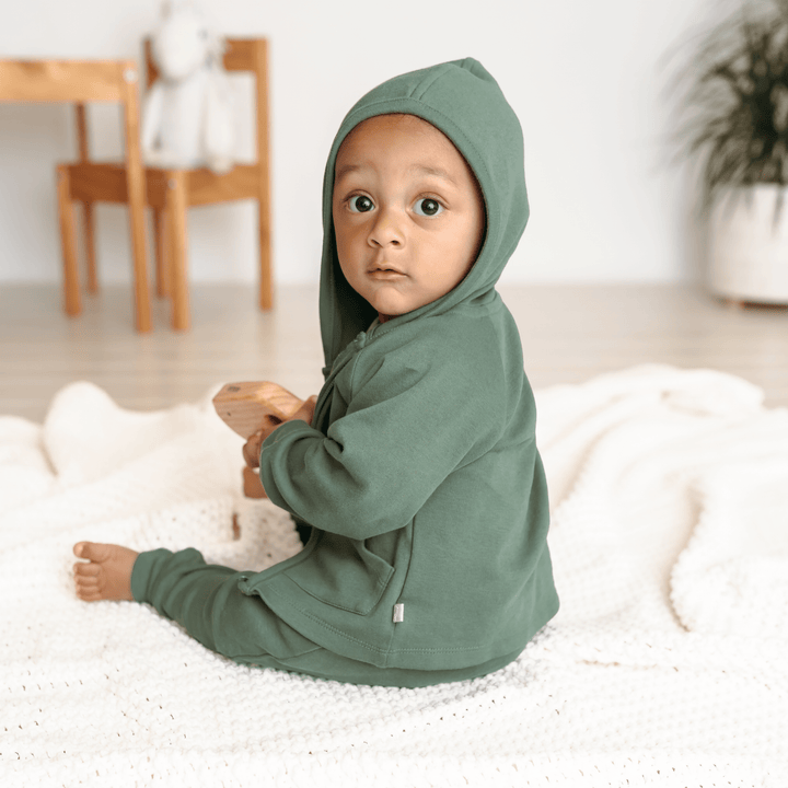 Organic cotton baby hoodie in basil green color made with eco-friendly dyes