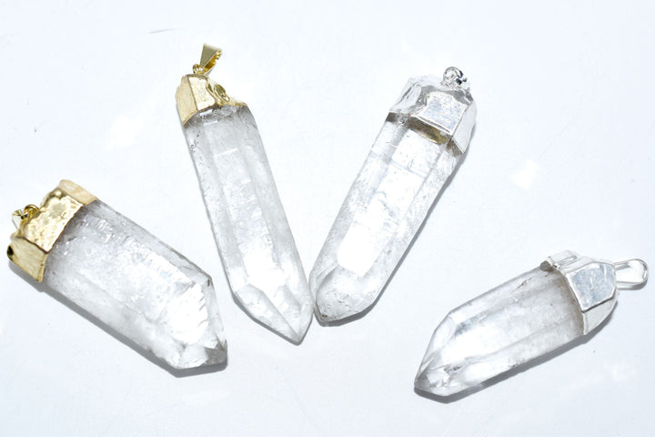Clear quartz crystal point pendant with gold plated metal setting on white background