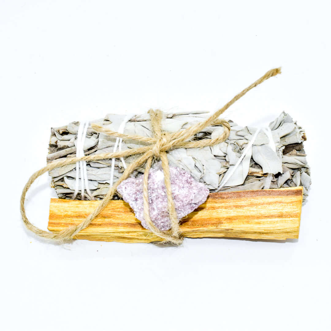 Palo Santo, crystal, and sage smudge bundle for spiritual cleansing and positive energy.