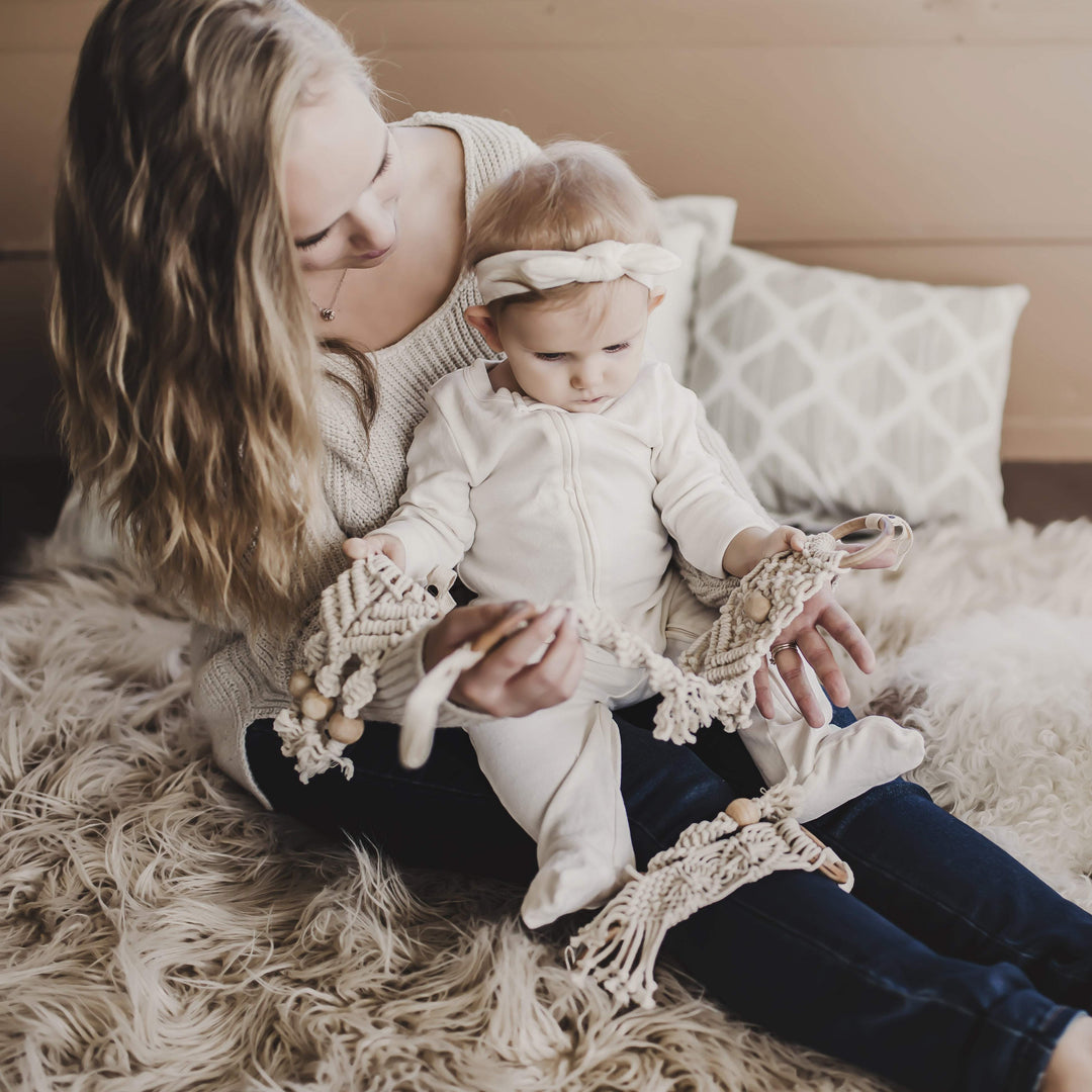 Hand-knotted organic cotton macrame diamond toy with wooden beads and stroller clip attachment